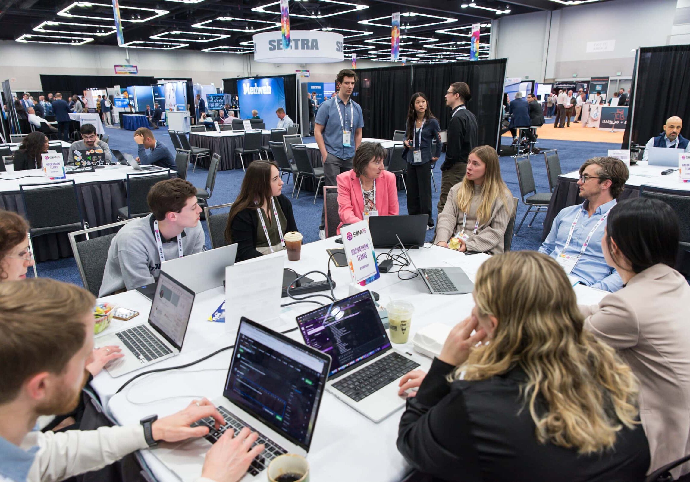 Healthcare professionals engaging in interactive learning sessions at the SIIM Annual Meeting, exploring advanced imaging technology and networking opportunities.