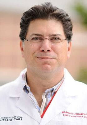 Renowned medical professional in radiology attending the SIIM Annual Meeting for networking and learning about the latest innovations in medical imaging.