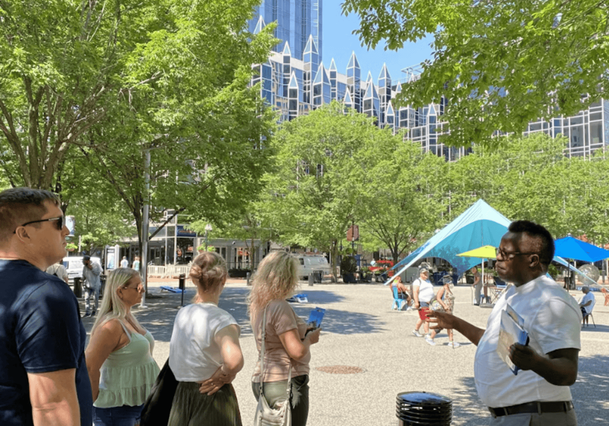 Innovative SIIM Annual Meeting attendees engaging outdoors in a city park with modern skyscrapers and green trees, highlighting imaging, medical technology, and networking opportunities at the conference.